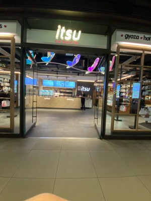 Glass doors with silver frame ahead. Pull from handles in centre to open.