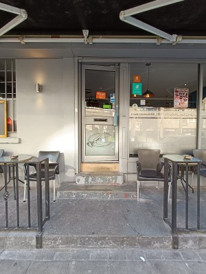 From street, facing venue. Step up to seating. Doorway at back.