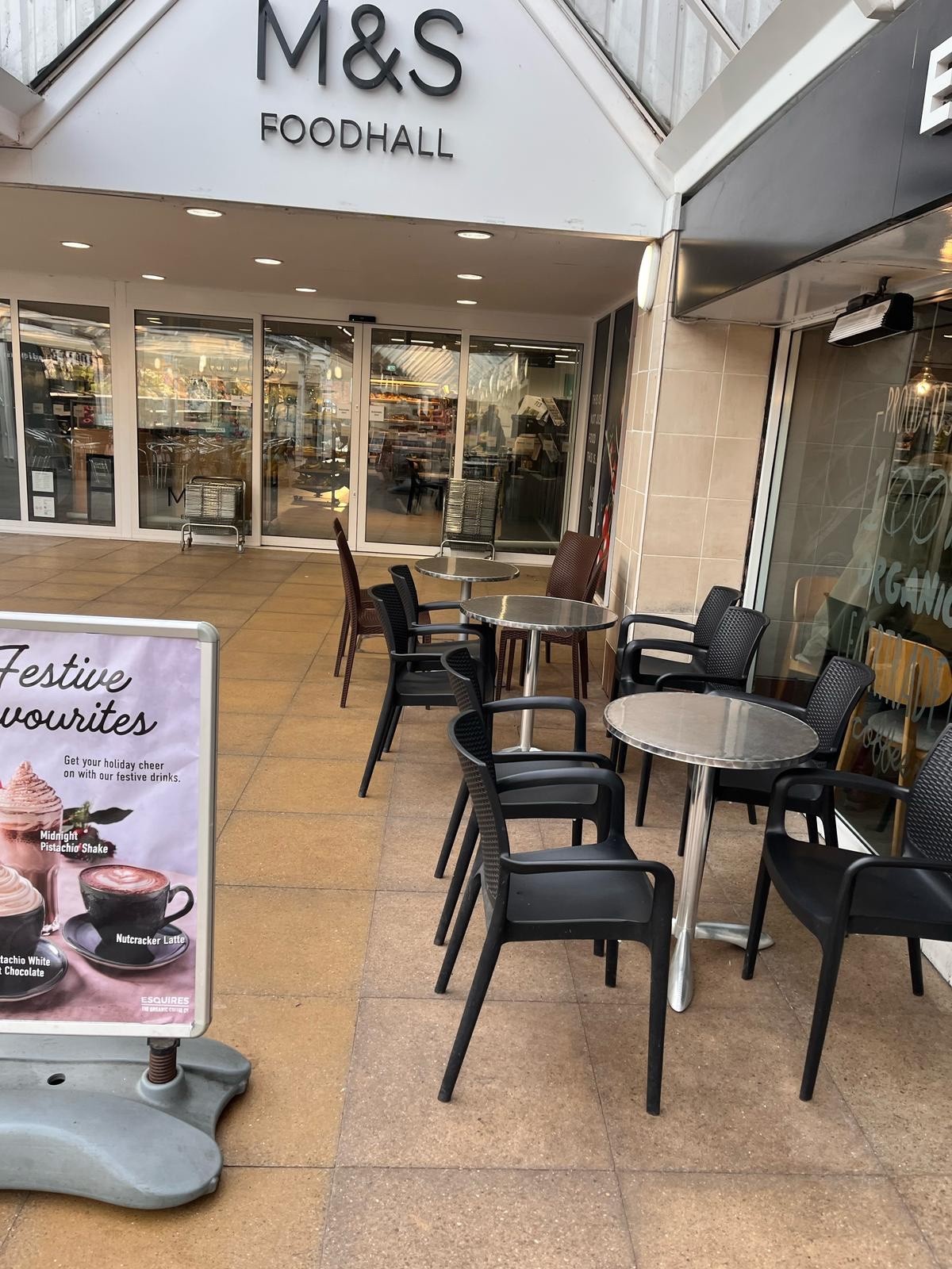 Large specials menu next to seating. Table and chairs are directly outside cafe and next door to M&S. Dog Friendly with water bowls outside/treats