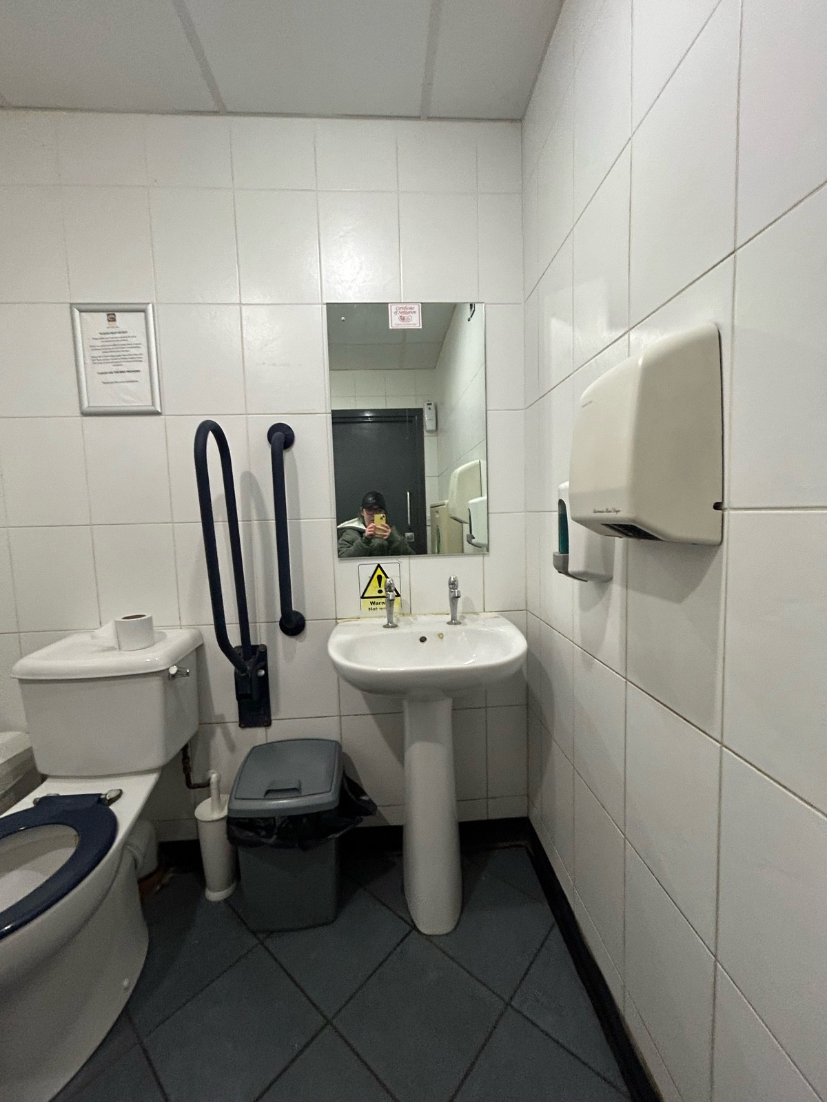 Slightly lowered sink, seat height mirror a grab rail and transfer rail to the right of the toilet hand soap and dryer seat height on right side wall