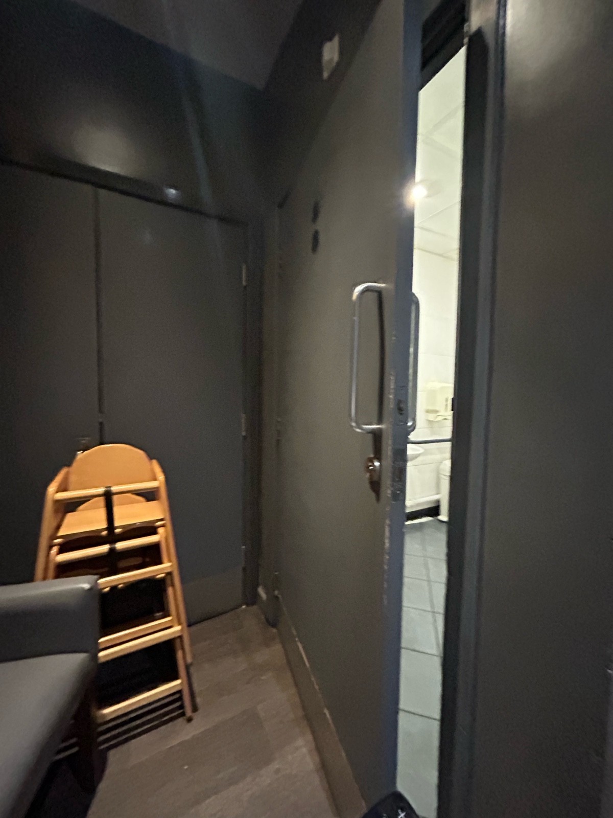 A height chair and chair was front of the door stopping it fully opening but still had enough space to pull door open and get into the toilet