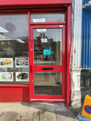 Red framed glass door. Push red handle on left to open.