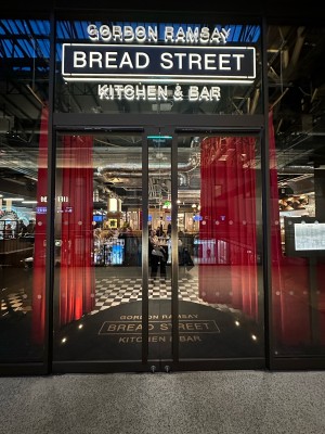 Glass doors with black frame. Push black handles in centre to open.