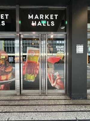 Glass doors ahead with photos. Pull silver metal handles in centre to open.