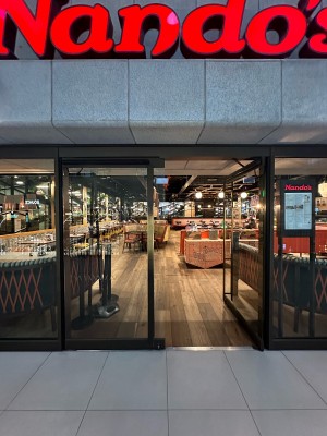 Glass doors with black frame. Push handles in centre to open.