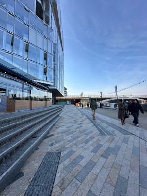 From bottom of steps facing right. Ramp ahead. Steps along left.
