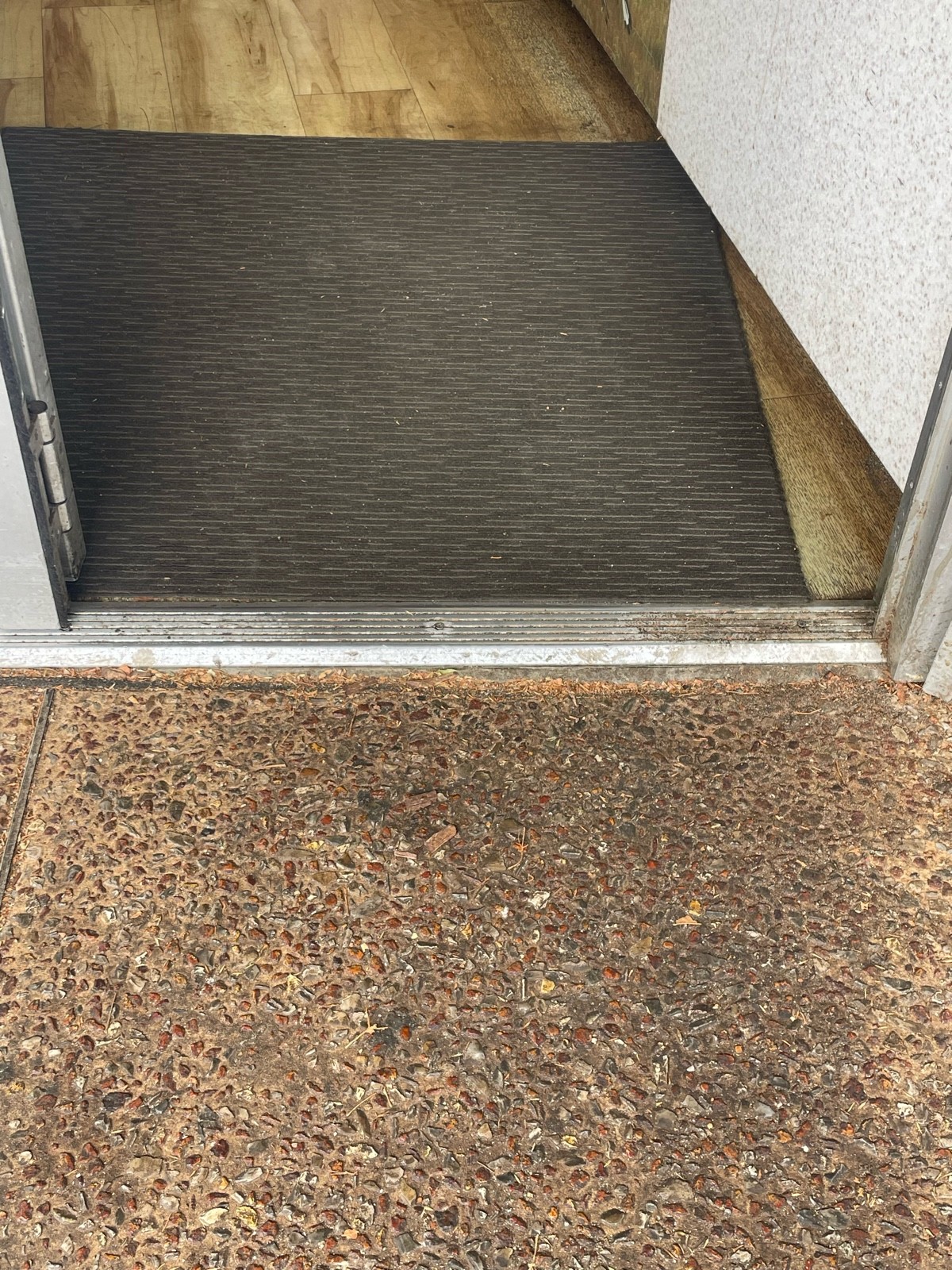 Small bump at foot of door. Doormat after door