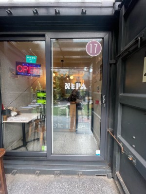 Glass doors with black frame ahead. Slide silver metal handle from right to left to open.