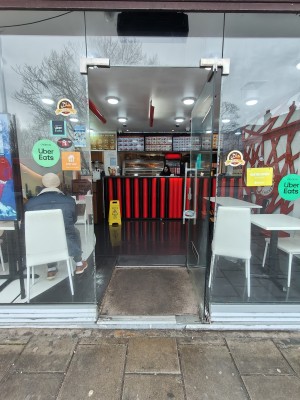 Glass door. Push silver handle on left to open.