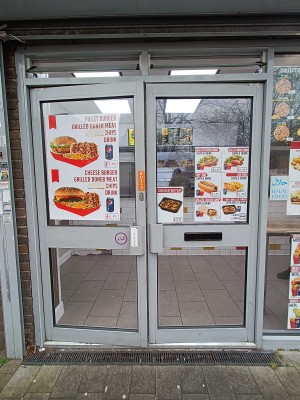 Glass doors with silver, metal frame. Pull from middle to open.