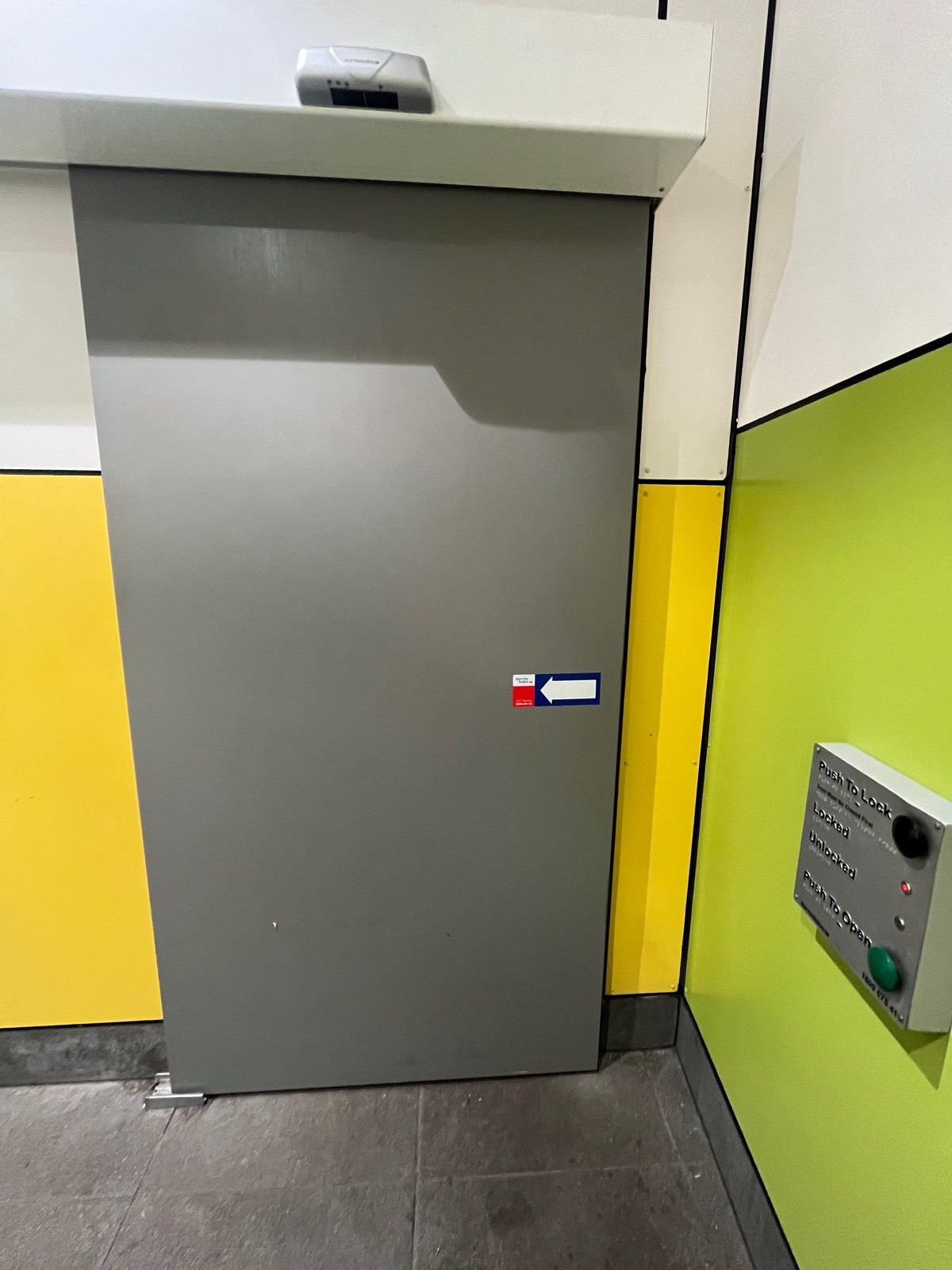 Back of door. Push buttons to lock and open on right wall. Door slides open to left.