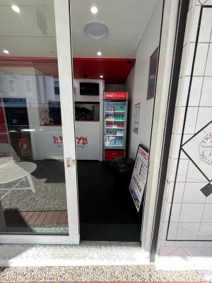 Glass door with white metal frame slides open to left.