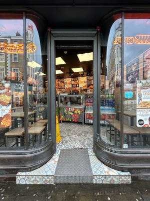 Open archway ahead with grey metal frame.