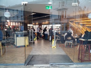 Glass doors ahead. Push metal handles in  enter to open.