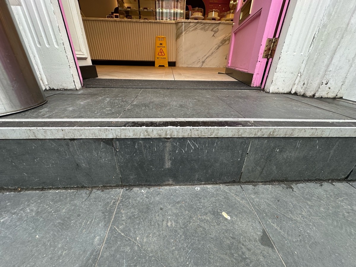 One step up before door. Doormat after door.