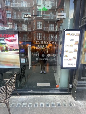 Glass door ahead. Push silver metal handle on left to open.