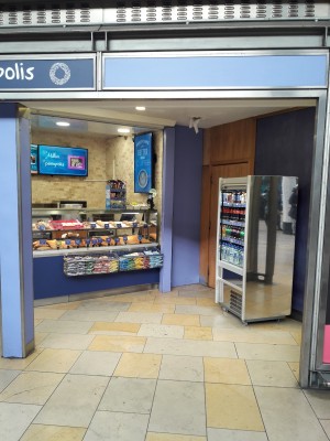 From station facing venue. Opening ahead. Counter at the back.