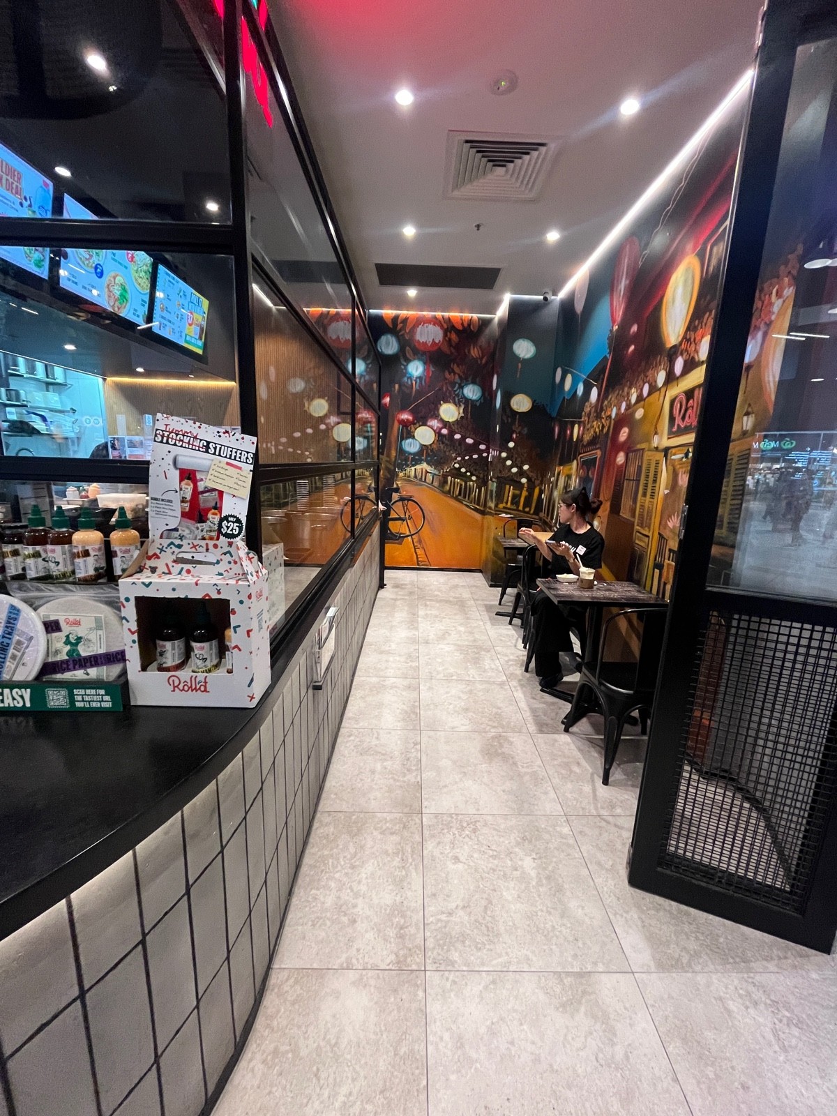 From doors facing left. Tables and chairs along right wall ahead.