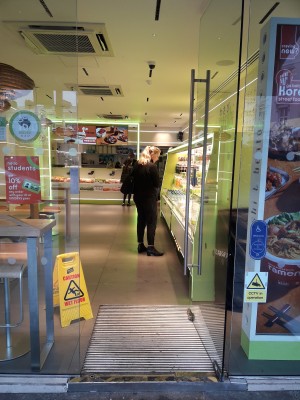 Glass door ahead. Push handle on left to open.