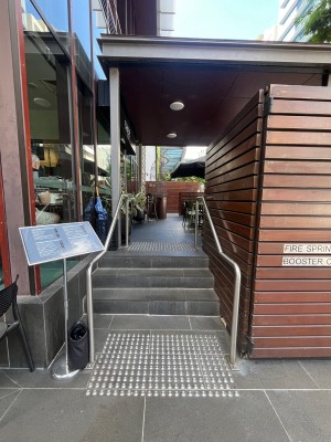 Path to entrance from street. Doors on left wall ahead.