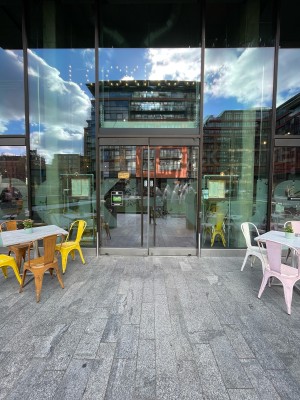 Metal-framed glass doors. Push from metal handles at centre to open.