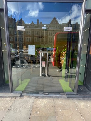Glass doors ahead. Push silver metal handles in centre to open.