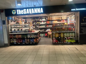 Open archway ahead. Product displays on left and right.