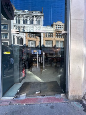 Glass doors. Push silver handles in centre to open.