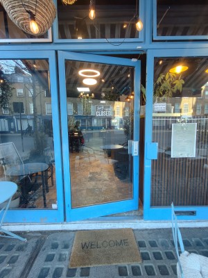 Blue framed glass door. Push blue handle on right to open.