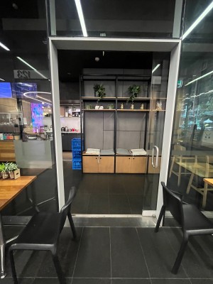 Glass door with silver handle on left. Door slides open to right.