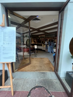 Glass doors with silver metal frames. Push from middle.