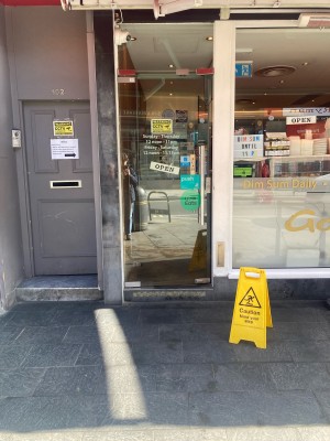 Glass door ahead. Push door to open via silver grab rail on right.