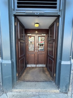 Brown doors ahead. Push in centre to open.