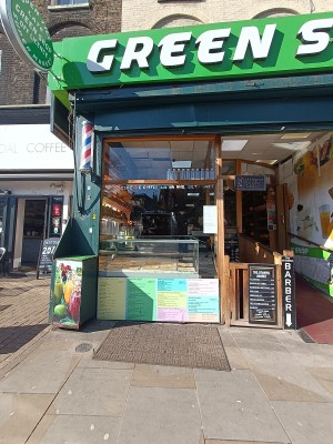 From street, facing venue. Counter and display at back. Path on right into shop.