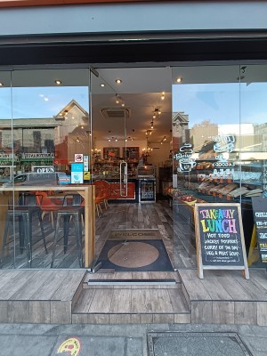 Glass door with silver handle on right. Push to open.