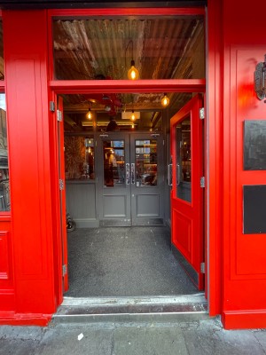 Glass paneled doors with red frame. Push handles in center to open.