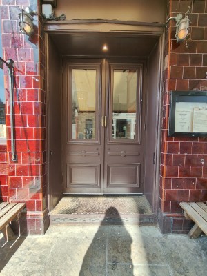Brown framed glass doors. Pull golden handles in centre to open.
