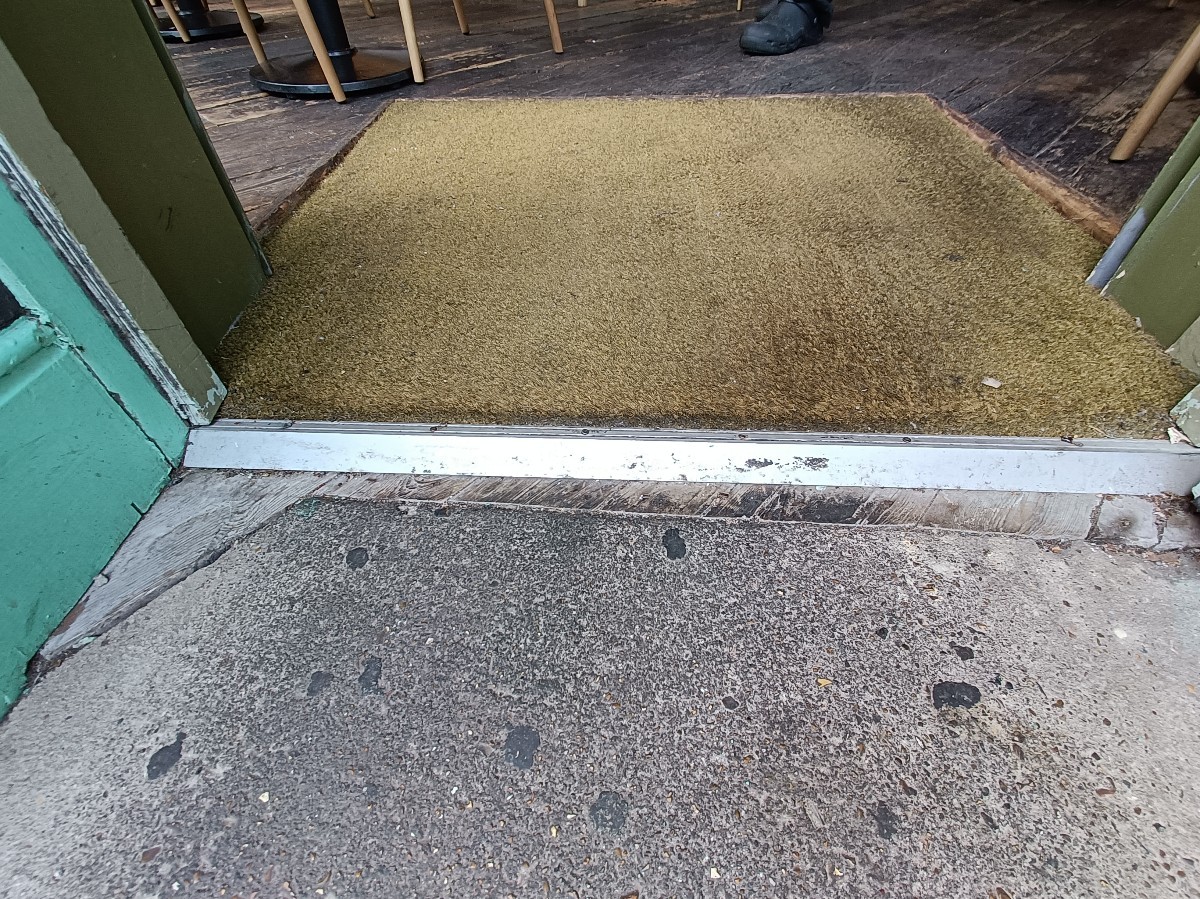 Small bump at threshold, doormat after.