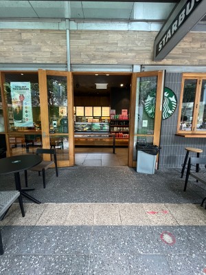 Path to entrance through outdoor front seating. Doors ahead.