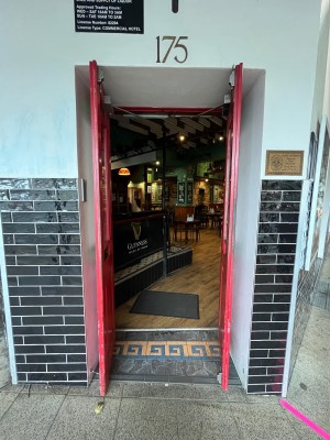 Glass doors with red wooden frame. No handles, doors pushed open from inside.