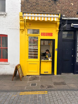 From road facing venue. Kiosk only. Displays on left, service counter on right.