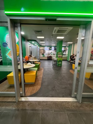 Glass doors with grey metal frames slide open from middle.