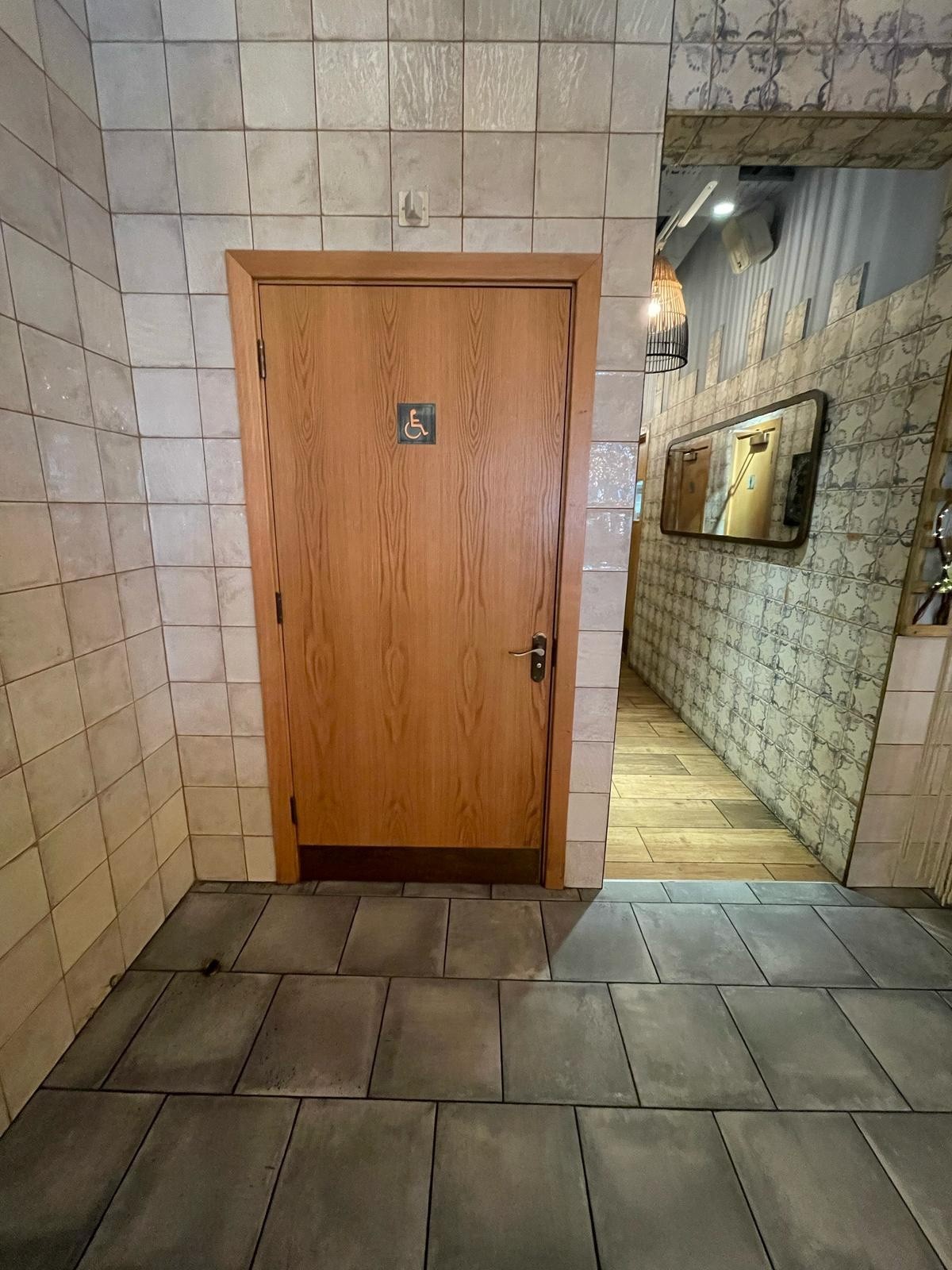 From end of half booth on left facing right. Bathroom door ahead on back wall.