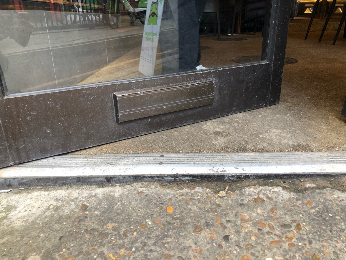 Metal bump at foot of door. Doormat following.