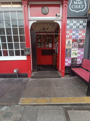 1 step up to wooden red door.