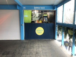 From sidewalk facing venue, entrance straight ahead.