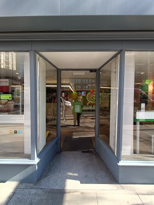 From street, facing venue. Open ahead to glass door at back. Silver handle on left. Pull to open.