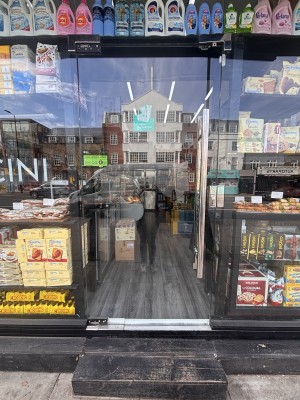 Glass door ahead. Push metal handle at center right to open.