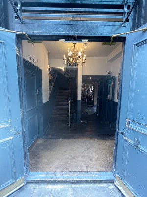 Blue doors. Pull open via handles in centre.