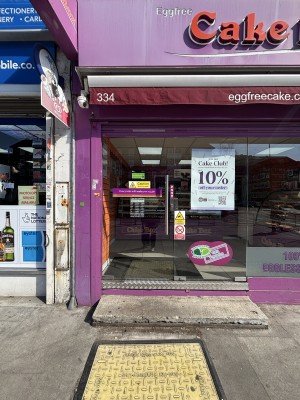 Glass door ahead. Push on right to open. Doormat after.